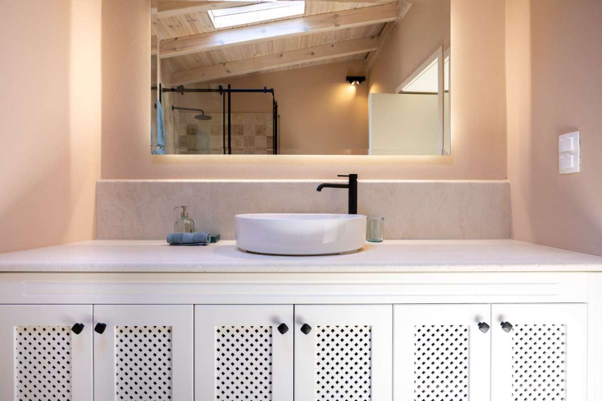 Stone vanity with backlit mirror